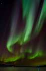 Iceland. Northern Lights over fjord Isafjardardjup near Isafjordur view towards Hornstrandir. Art Print